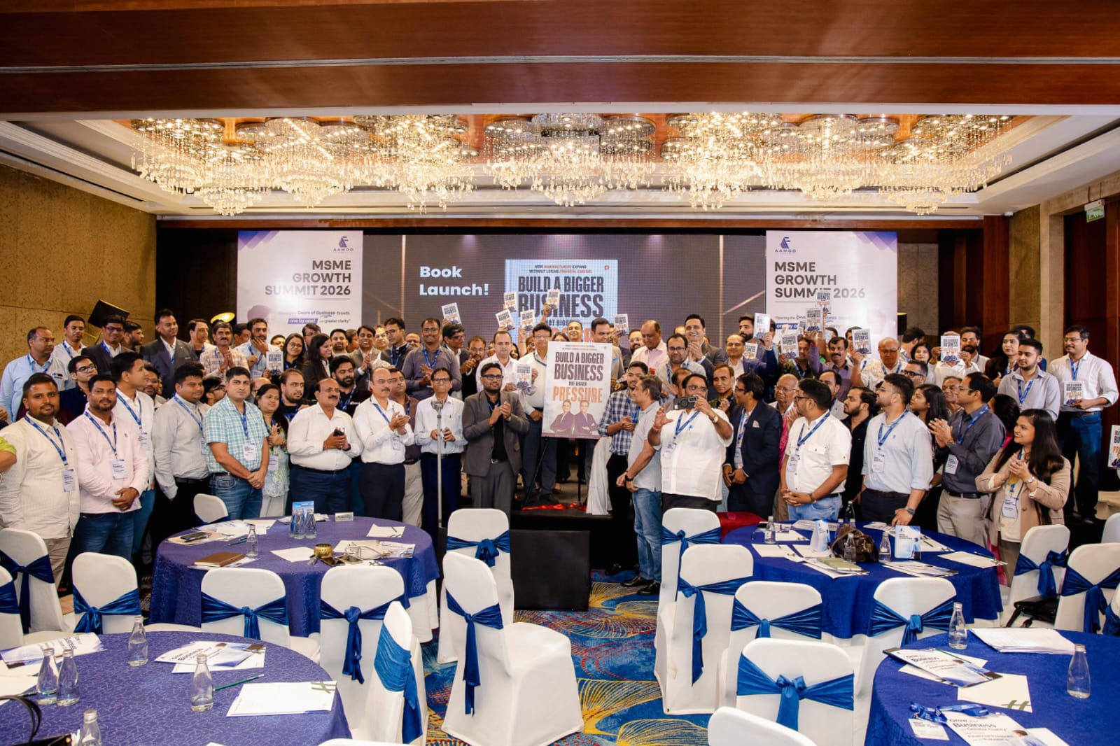 Promoters holding the launched book at MSME Growth Summit 2026